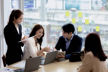 Meeting room atmosphere and business groups are meeting, discussing and planning business operations for more profitable growth. Concept of business meeting and company administration.