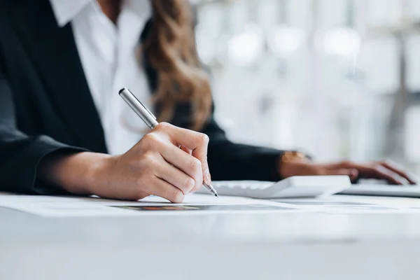 Business woman holding financial documents, she owns a startup company, she sits checking the company\'s financial summary prepared by the finance department. Management concept of startup company.