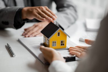 Emlakçılar, konut modellerini müşterilere ayrıntılı bir şekilde anlatma, evler ve satın alma kredileri hakkında bilgi verme ve sunma konularında açıklar. Gayrimenkul ticareti.