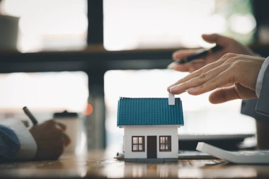 Kiralama şirketi çalışanı, müşteri kira sözleşmesini imzalamadan önce kira sözleşmesinin detaylarını ve şartlarını açıklamadan önce detayları tartışıyor. Emlak kiralama fikirleri.