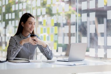 Beautiful Asian woman is a businesswoman who leads a new generation of startups, a woman who runs and manages a business plan to build confidence and stability in business, woman-led business concept.
