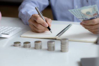 Individuals are taking note of income and expenditures for proportional, investment savings, money growth, stock investments. Idea of investing money to make it worthwhile to grow and be sustainable.
