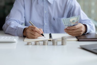 Individuals are taking note of income and expenditures for proportional, investment savings, money growth, stock investments. Idea of investing money to make it worthwhile to grow and be sustainable.