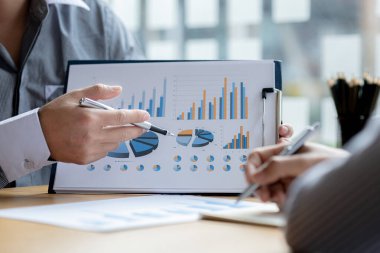 Atmosphere brainstorming session of a startup company, two founders of the company attended a meeting to plan the management and financial growth of the company. Management startup company concept.