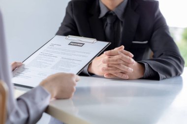 İş başvurusu yapan kişi başvuru formunu sunan bölüm müdürüyle iş görüşmesine gitmeden önce İnsan Kaynakları Departmanı 'ndan özgeçmişini kontrol ediyor. İş başvurusu fikirleri.