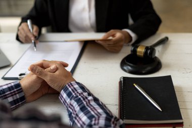 Client was listening to a lawyer advising on an embezzlement case, explaining the details of the proceeding and gathering evidence to file a lawsuit against the defendant. The concept of litigation.