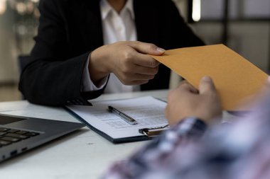 Attorneys are accepting documents from clients who come in to testify in case of embezzlement from business partners who venture into business. The concept of hiring a lawyer for legal proceedings.