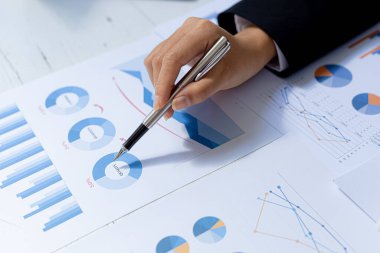 Business women are looking at the company's financial documents to analyze problems and find solutions before bringing the information to a meeting with a partner. Financial concept.