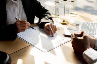 Client was listening to a lawyer advising on an embezzlement case, explaining the details of the proceeding and gathering evidence to file a lawsuit against the defendant. The concept of litigation.