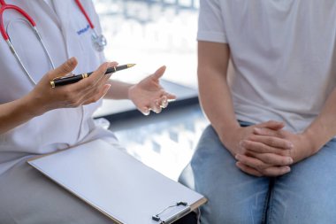 An examination room atmosphere in a hospital where doctors and patients are examining and diagnosing and prescribing medications for symptomatic treatment. The concept of disease diagnosis.
