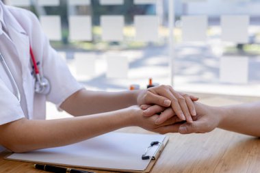 Doctor shook hands to encourage the patient after informing the results of the examination and informing the patients about treatment guidelines and prescribing medicines. Disease examination concept.