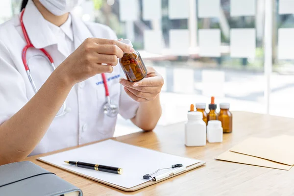 Pharmacy is holding a bottle, a public health professional with the most expertise in medicine in the health profession, responsible for all medicines, their procurement, production, and distribution.