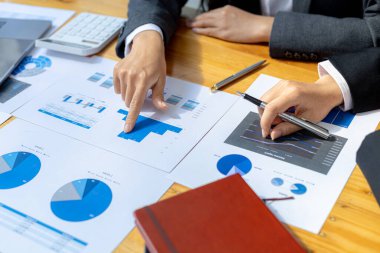 The sales department is having a monthly summary meeting to bring it to the department manager, they are verifying the correctness of the documents that are prepared before bringing in to the manager