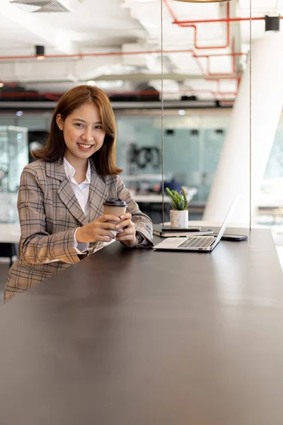 Portrait of a young beautiful Asian woman in a office room, concept image of Asian business woman, modern female executive, startup business woman, business leader woman.