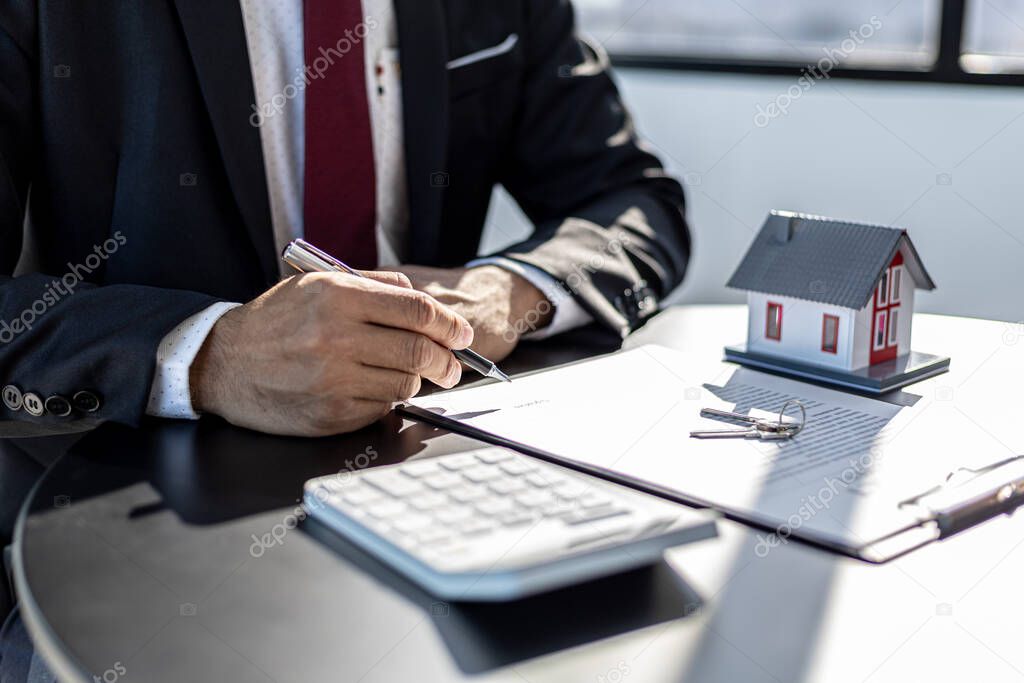 Rental company employee is checking the documents for the customer to agree to sign the rental contract, explaining the details and the terms and conditions of the rental. Real estate rental ideas.