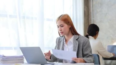 Asian women working in the office, young Asian business women as business executives, founding and running start-up executives, young female business leaders. Startup business concept.