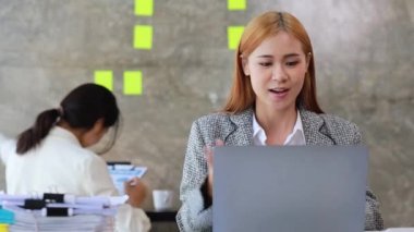 Güzel Asyalı iş kadını özel ofisinde oturuyor, eşiyle bilgisayarından video görüşmesi yapıyor, yeni başlayan bir şirketin kadın yöneticisidir. Mali yönetim kavramı