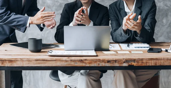 Company meeting room has businessmen and finance managers meeting together on finance topics, they are applauding after the meeting is over. Concept company financial management