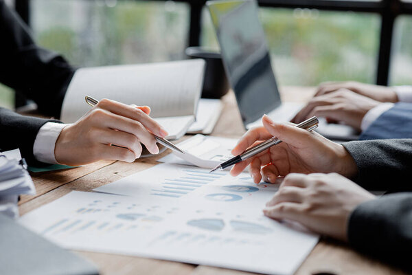 Asian business man are meeting to summarize the company's operating, financial, profit and loss results. Management of startup companies. Profitable management concept and growing management.