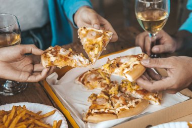 İnsanların yemek için tepside pizza toplamasını, yeni şirket partilerini, yeni yıl partilerini, şirket yıllık toplantılarını, alkollü içecekleri. Şirket çalışanları parti yemekleri, pizza kutlamaları..