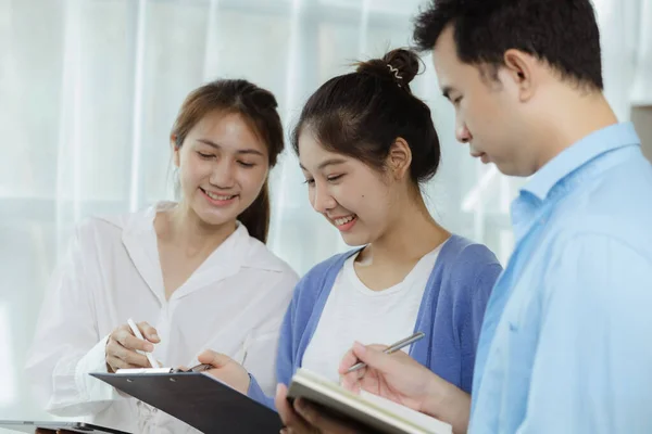 Groups Asian people chatting, business men and women meeting in a conference room, young business man running and running startups, young and energetic group running companies. Startup company concept