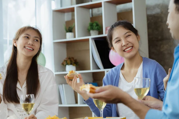 Group of young Asians having fun at company parties, startup parties, new year parties, annual company parties, alcoholic beverages. Company employee party catering ideas, celebrations.