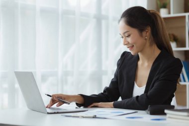 Beautiful Asian woman is a businesswoman who leads a new generation of startups, a woman who runs and manages a business plan to build confidence and stability in business, woman-led business concept.