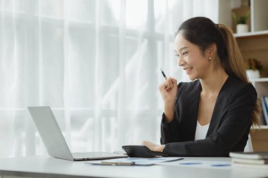 Portrait of a young beautiful Asian woman in a office room, concept image of Asian business woman, modern female executive, startup business woman, business leader woman.