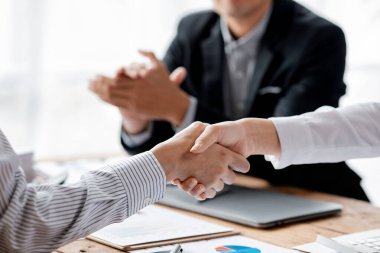Business investor group holding hands, Two businessmen are agreeing on business together and shaking hands after a successful negotiation. Handshaking is a Western greeting or congratulation.