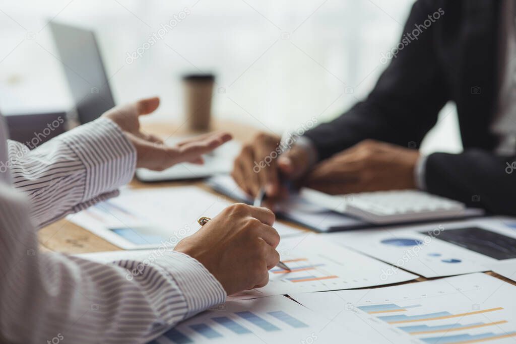 Two businessmen are reviewing monthly sales documents for analysis and marketing plans for more sales growth, they are the founders of young companies co-founding startups. Sales management concept.