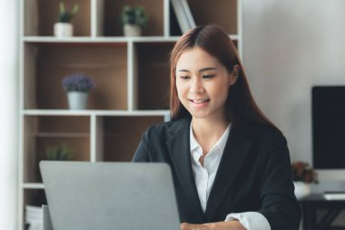 Beautiful Asian woman is a businesswoman who leads a new generation of startups, a woman who runs and manages a business plan to build confidence and stability in business, woman-led business concept.