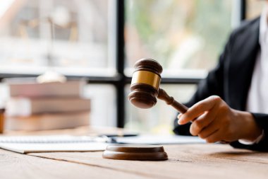 A person holding the hammer of justice, the concept of a lawyer or a law enforcement officer is holding a hammer similar to the judgment of a lawsuit.