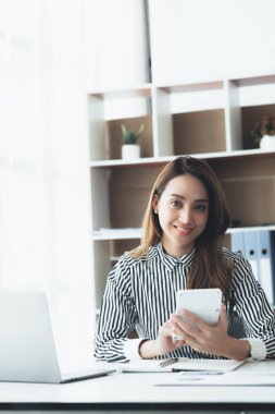 Beautiful Asian woman is a businesswoman who leads a new generation of startups, a woman who runs and manages a business plan to build confidence and stability in business, woman-led business concept.