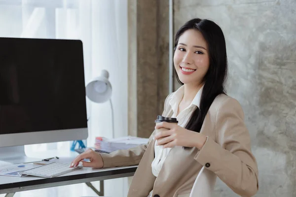 Beautiful Asian woman managing a company, business executive, marketing executive, founder of a startup company providing marketing services to clients. Marketing management concept.