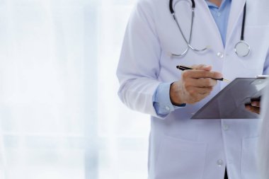 Doctors are giving advice on treatment to patients in hospital examination rooms, treating diseases from specialists and providing targeted treatment. Concepts of medical treatment and specialists.