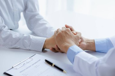 Doctor touches the arm to encourage the patient in the hospital examination room, treating the disease from a medical professional and giving treatment on the spot. Concepts of medical treatment.