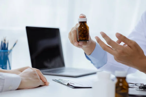 Doctors are giving advice on medication to patients in hospital examination rooms, treating diseases from specialists and providing targeted treatment. Concepts of medical treatment and specialists.