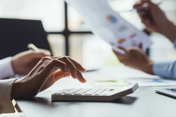 A conference room where executives and marketers are looking at sales documents to analyze, plan marketing and do sales promotions, they are brainstorming. Sales management concept.