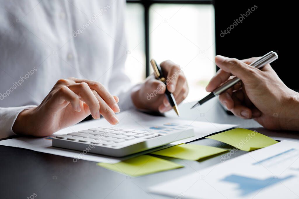 Two businessmen pointed to the material for the meeting, working together to plan to develop and solve common business problems. Concept of business management for growth and quality.