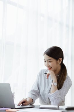 Portraits of beautiful Asian businessmen, business women leaders, women working in a startup company office, managing a growing and profitable company. Business management concepts from female leaders