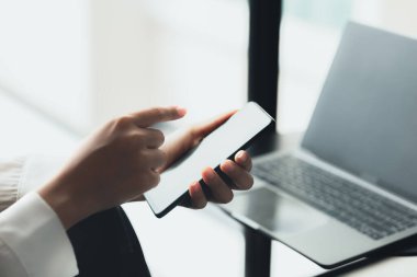 Asian woman using mobile phone, she surfs internet and social media on smartphone, chatting on app with friends. The concept of using technology in communication and the use of the Internet.