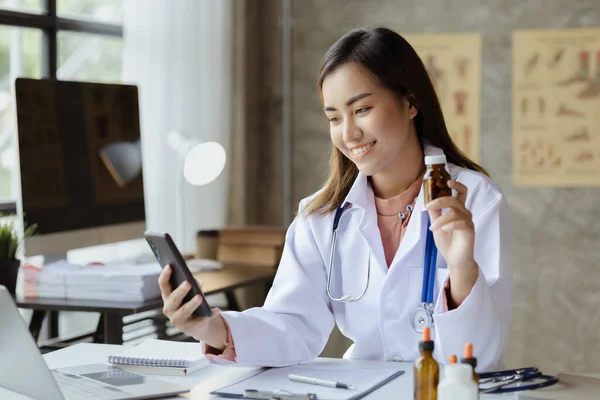 A female doctor is on a video call with a patient via a smartphone to provide advice on disease, expert consultation and treatment of the disease, targeted treatment, medical concepts and specialists.