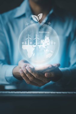 Person with Earth Hologram Renewable Energy, Earth Hologram and Wind Energy Used as Pure Renewable Energy to Reduce High Cost Oil Use, Wind Energy is a Natural that Reduces Global Warming. hot.