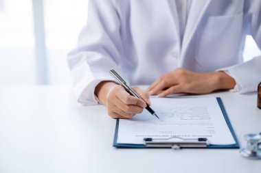 Doctors looking at patient's diagnostic documentation in the hospital's medical room, treating diseases from specialists and providing targeted treatment. Concepts of medical treatment and specialists