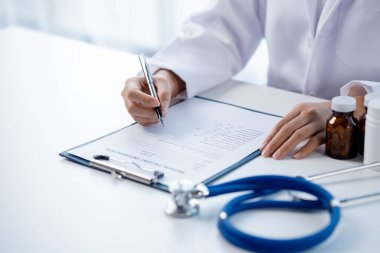 Doctors looking at patient's diagnostic documentation in the hospital's medical room, treating diseases from specialists and providing targeted treatment. Concepts of medical treatment and specialists
