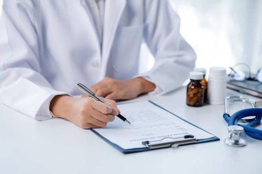 Doctors looking at patient's diagnostic documentation in the hospital's medical room, treating diseases from specialists and providing targeted treatment. Concepts of medical treatment and specialists