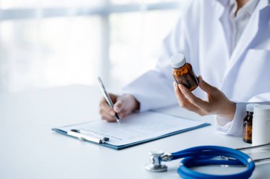 Physicians view diagnostic documents and hold medications in hospital rooms, treating diseases from specialists and providing targeted treatment. Concepts of medical treatment and specialists.