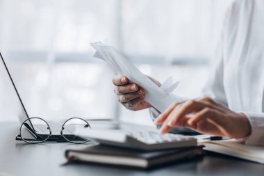 People are pressing calculators and carrying bills and bills to systematically allocate income and expenses, financial planning to keep finances in order. Personal finance management concept.