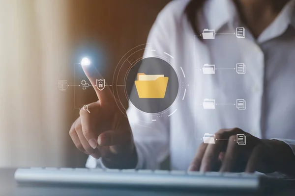 business man typing on a keyboard with holograms of digital document files, data files on computers stored as cloud databases can be viewed online and prevented data loss from the device.