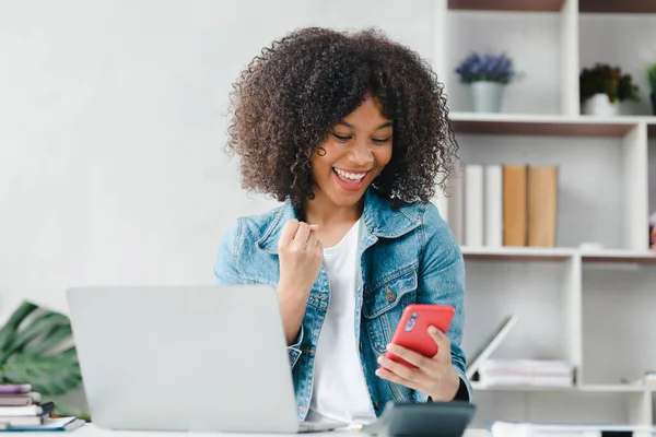 American teenage girl watching smartphone in white room at home, she is a student studying online at home, university student studying online, online web education concept.